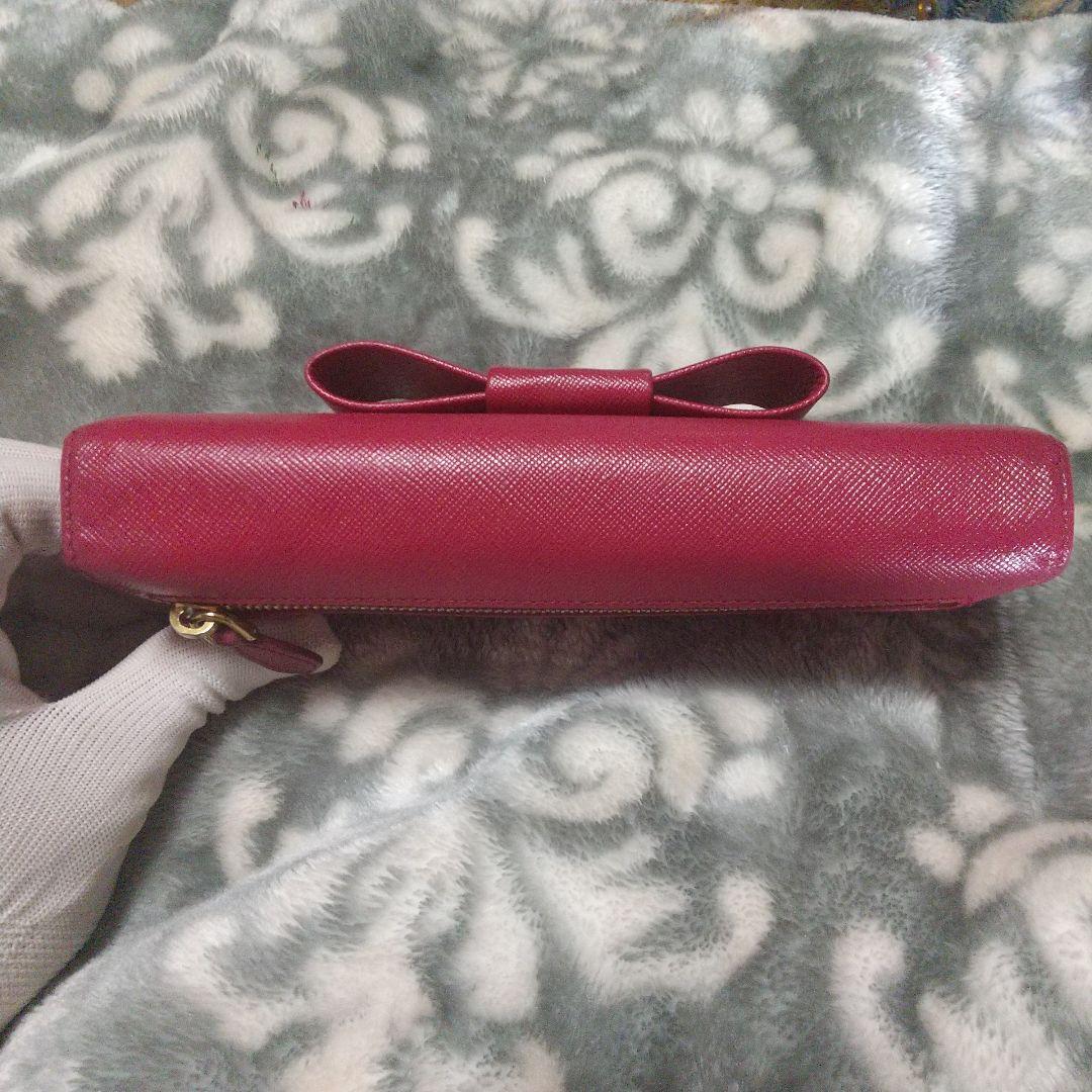 PRADA サフィアーノリボン付き レッド系 長財布 - メルカリ